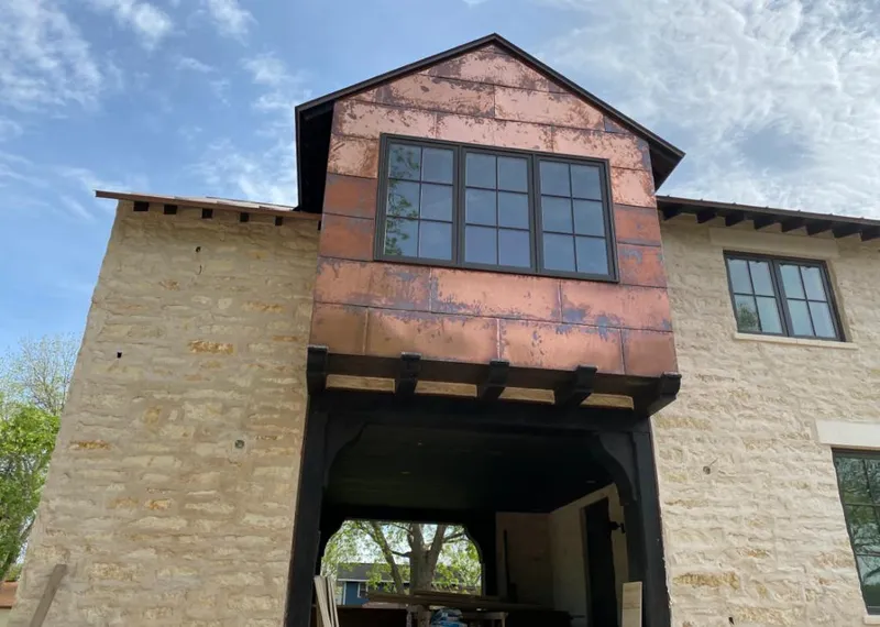 Copper metal panel facade on a stone building for Skylight Installation in Duvall